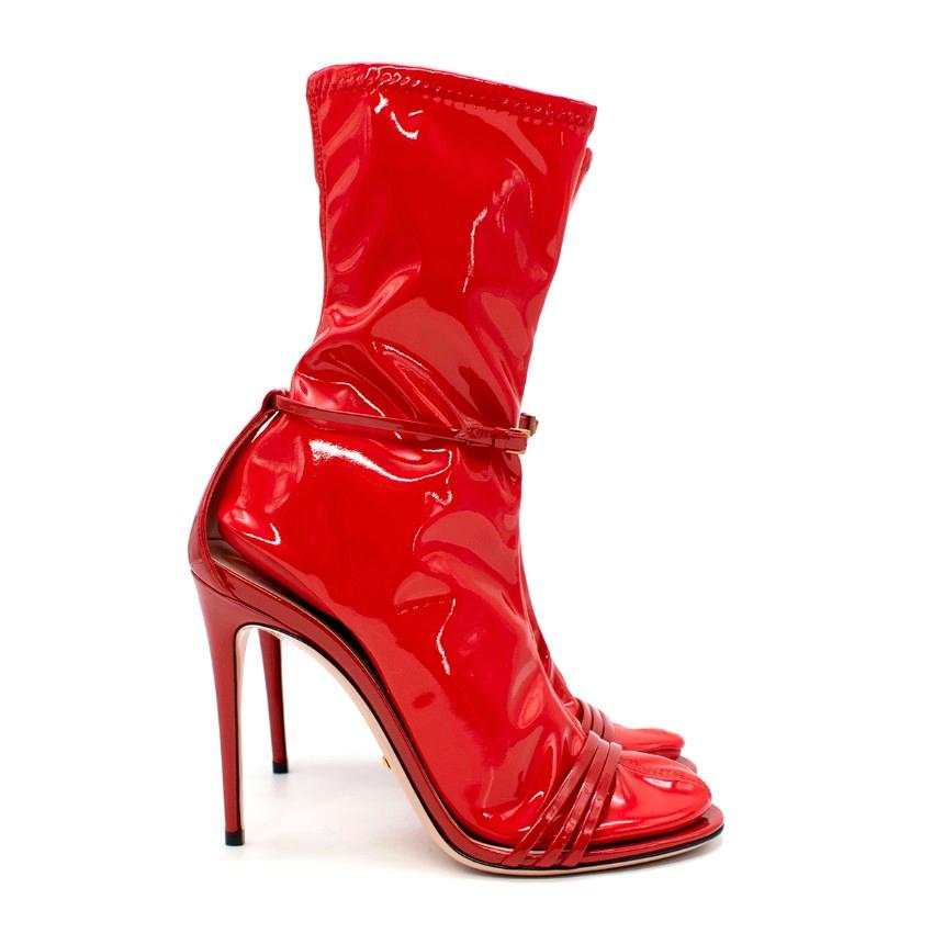 Gucci Ilse Red Patent Leather Latex Sock Sandals

- Option to wear as ankle boot featuring the tonal latex inner sock, or as a classic strappy heel without
- Round toe featuring three narrow patent leather straps
- Adjustable ankle strap with
