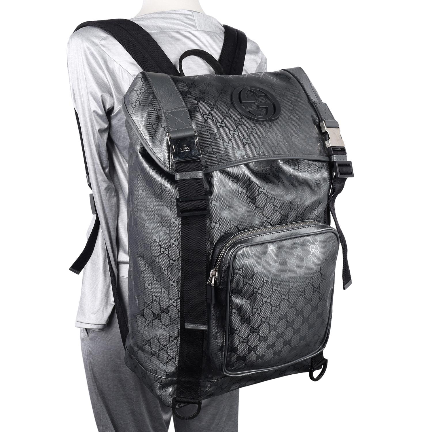 Authentic, pre-loved Gucci Imprime Monogram Interlocking GG Backpack in Black and Grey. Features Gucci GG imprime coated canvas, buckle and drawstring closure, external zippered pocket with a top grip handle and padded shoulder straps. The interior