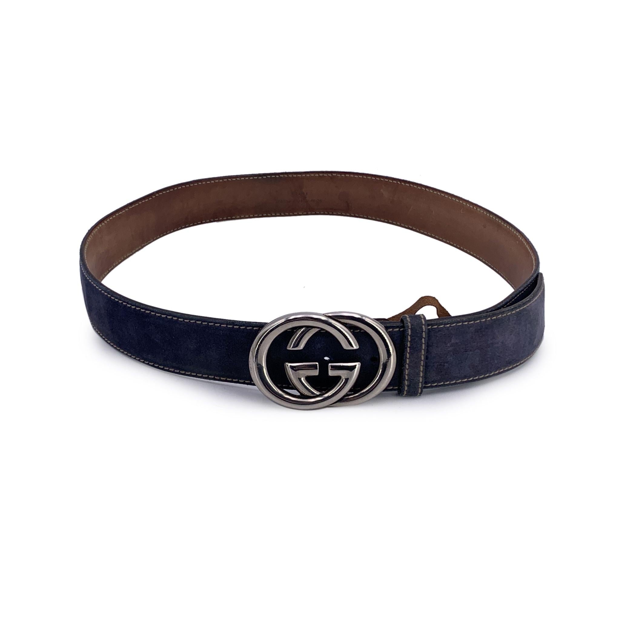 Gucci belt in indigo blue suede. Silver metal GG buckle (2\ inches - 5.1 cm tall). Width: 1.5 inches - 3.8 cm. 'GUCCI - Made in Italy' engraved on the reverse of the belt, serial number engraved on the reverse of the belt. 3 holes adjustment. Size: