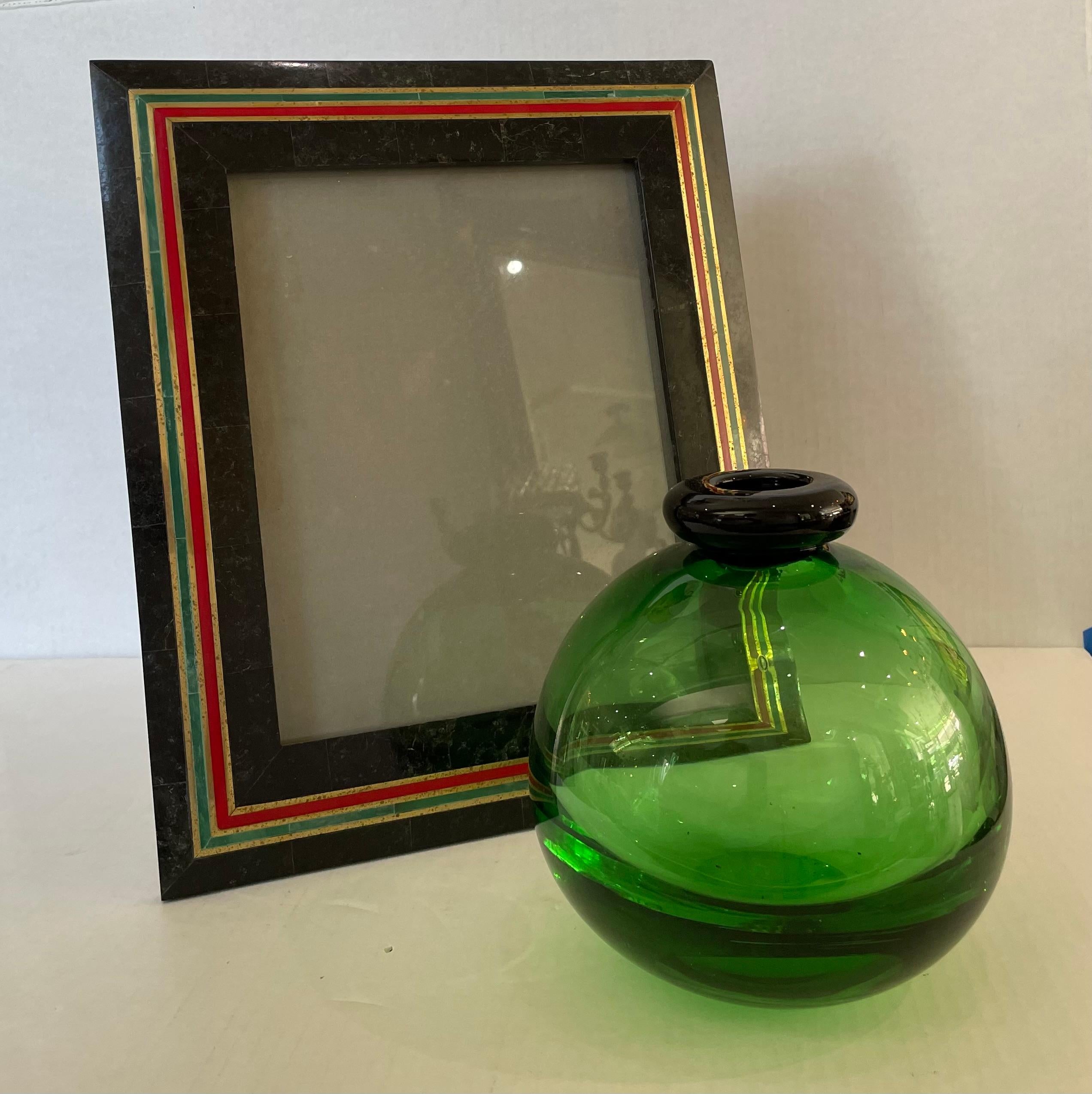 This stylish and chic tessellated marble and brass photo frame has taken its inspiration from the classic green and red of Gucci. 

Note: Will hold an 8