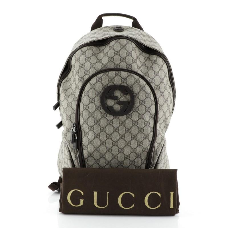 This Gucci Interlocking G Backpack GG Coated Canvas Medium, crafted from brown GG coated canvas, features adjustable canvas straps, exterior front zip pocket, interlocking GG logo at front and gunmetal-tone hardware. Its zip closure opens to a brown