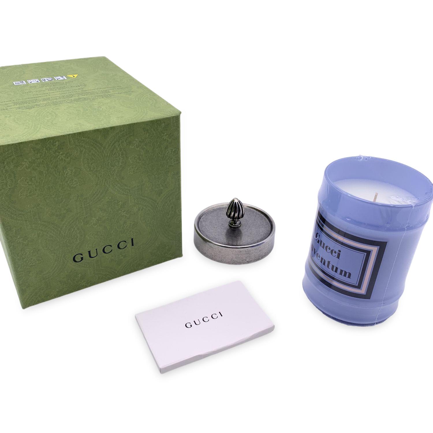 Beautiful Gucci 'Inventum' Scented candle. Wax is sscented with notes of pink rose and Taif Damask rose. It features a metal lid with an engraved knob, and the light blue glass jar (it may be repurposed once the candle has burned out).Made in Italy.