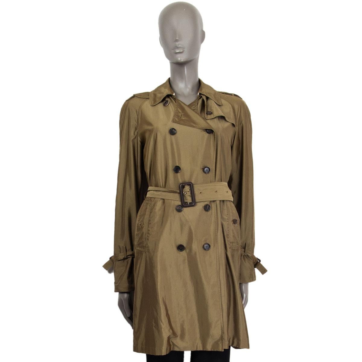 Gucci iridescent double-breasted trench coat in olive green polyamide (58%) and polyester (42%) with a flat collar, epaulettes, buttoned slit pockets and belted cuffs. Comes with a brown leather buckle matching belt. Closes on the front with