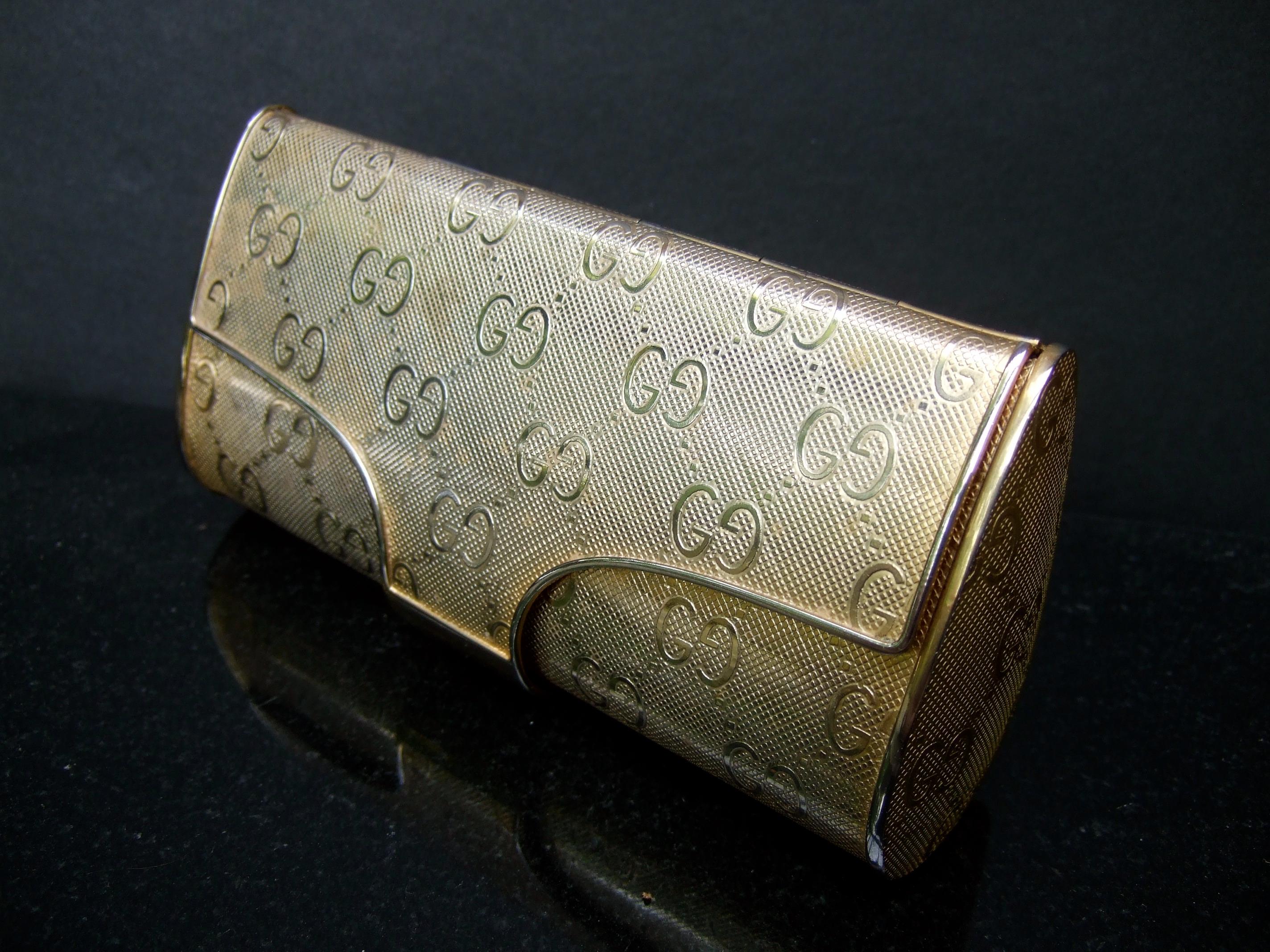 Gucci Italian rare gilt metal minaudiere' evening clutch c 1970s 
The elegant gold metal clutch is adorned with Gucci's G.G initials 
throughout the exterior

Makes a chic timeless accessory perfect for holidays & weddings 
The interior is designed
