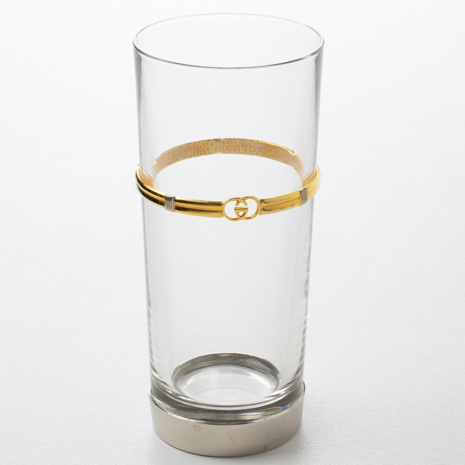 Entertaining means elegance with this Gucci barware set of crystal highball tumbler glasses featuring a gold-plated GG emblem.
This chic Italian hallmarked Gucci set of five glasses features tall tumbler-shaped crystal glasses with silver-plated