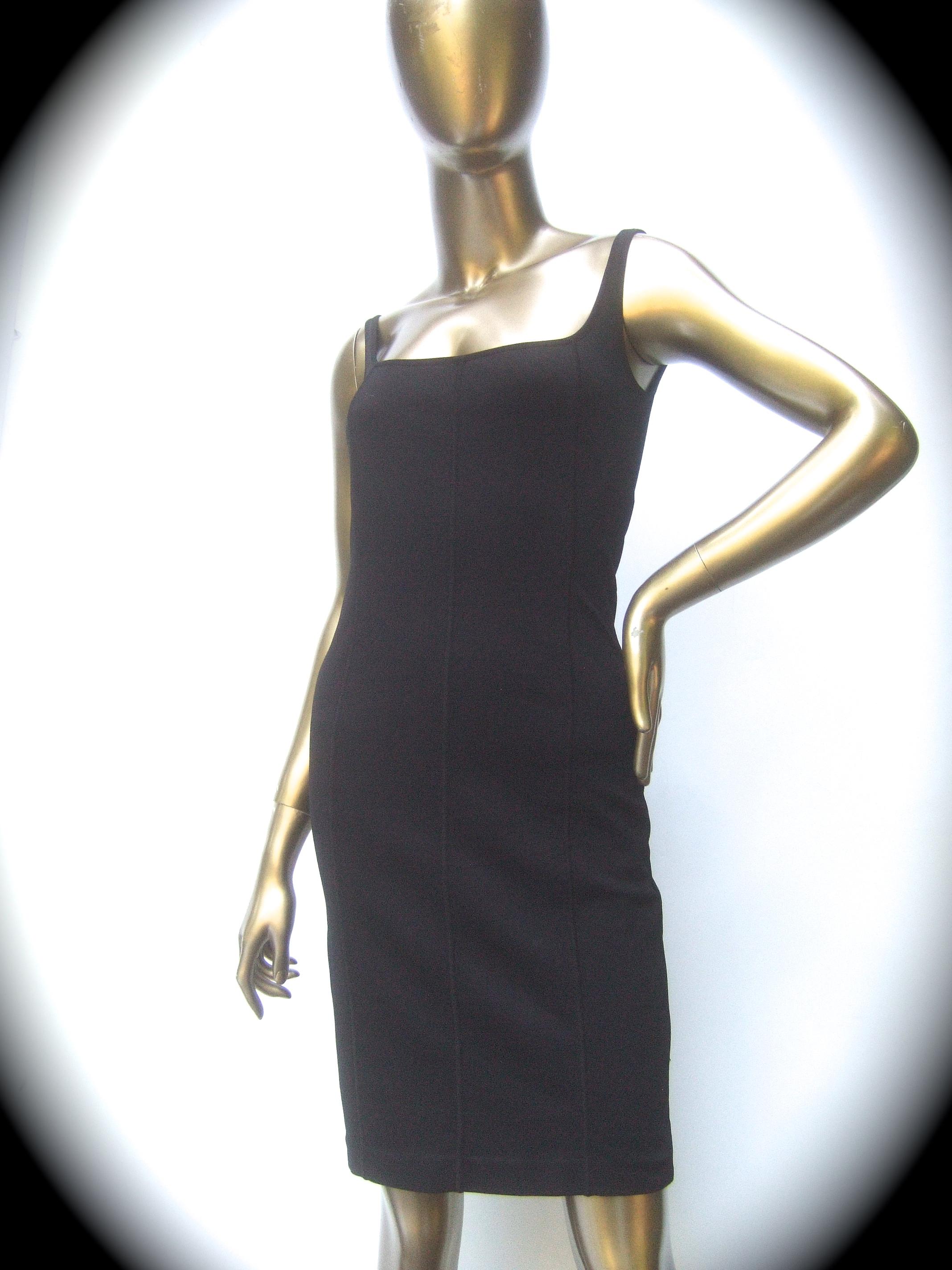 Gucci Italy Chic black stretch knit tank dress Tom Ford era c 1990s
The stylish knit dress contours and clings around the body
Accented with subtle vertical seams 4 inches apart throughout  
The dress is designed with a partial cutout back

The