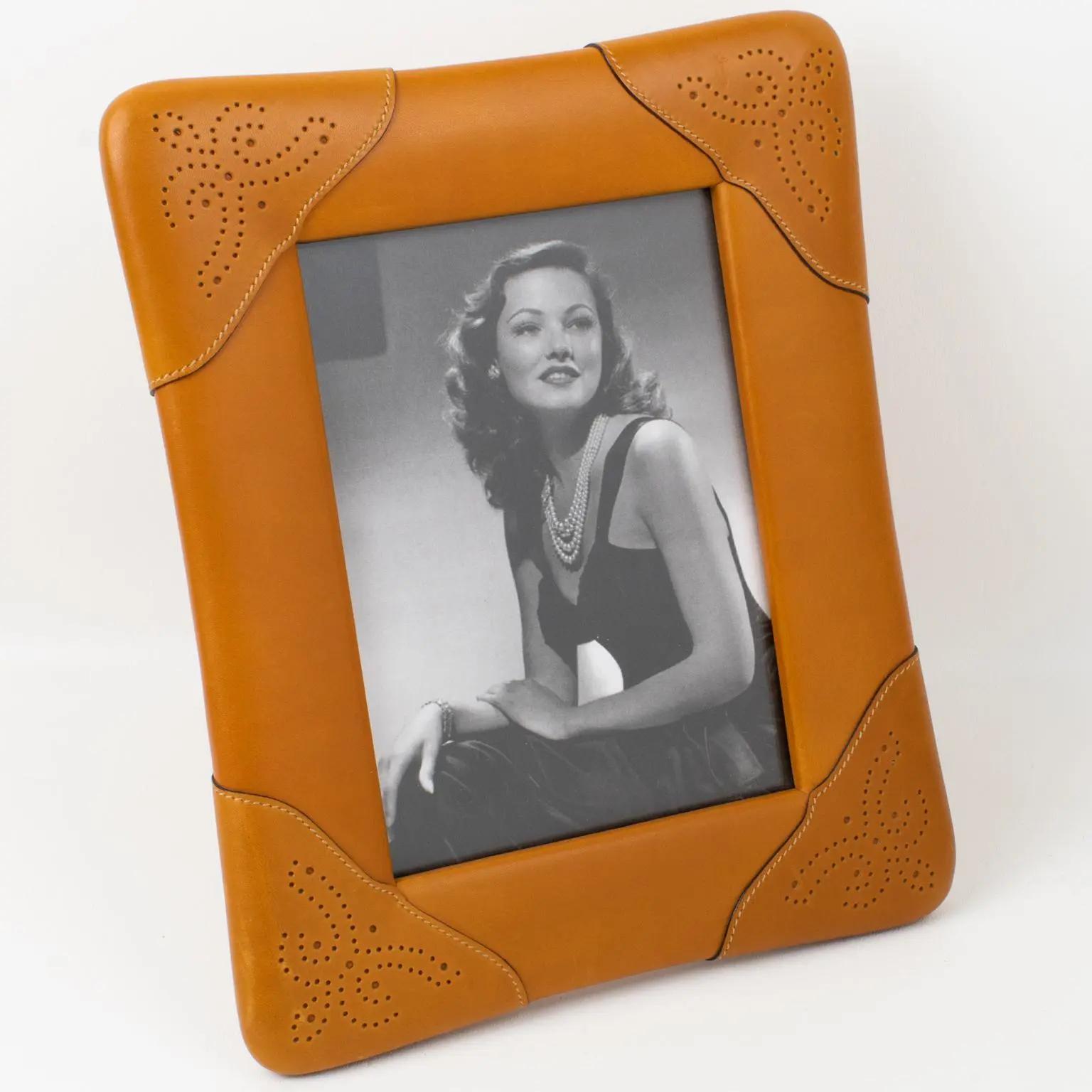 Add luxury to your interior with this Picture photo frame created by Italian designer Gucci. The timeless and elegant gold cognac calfskin leather has a textured pattern with ornate hand-stitched and pierced decor. The back and easel are in the same
