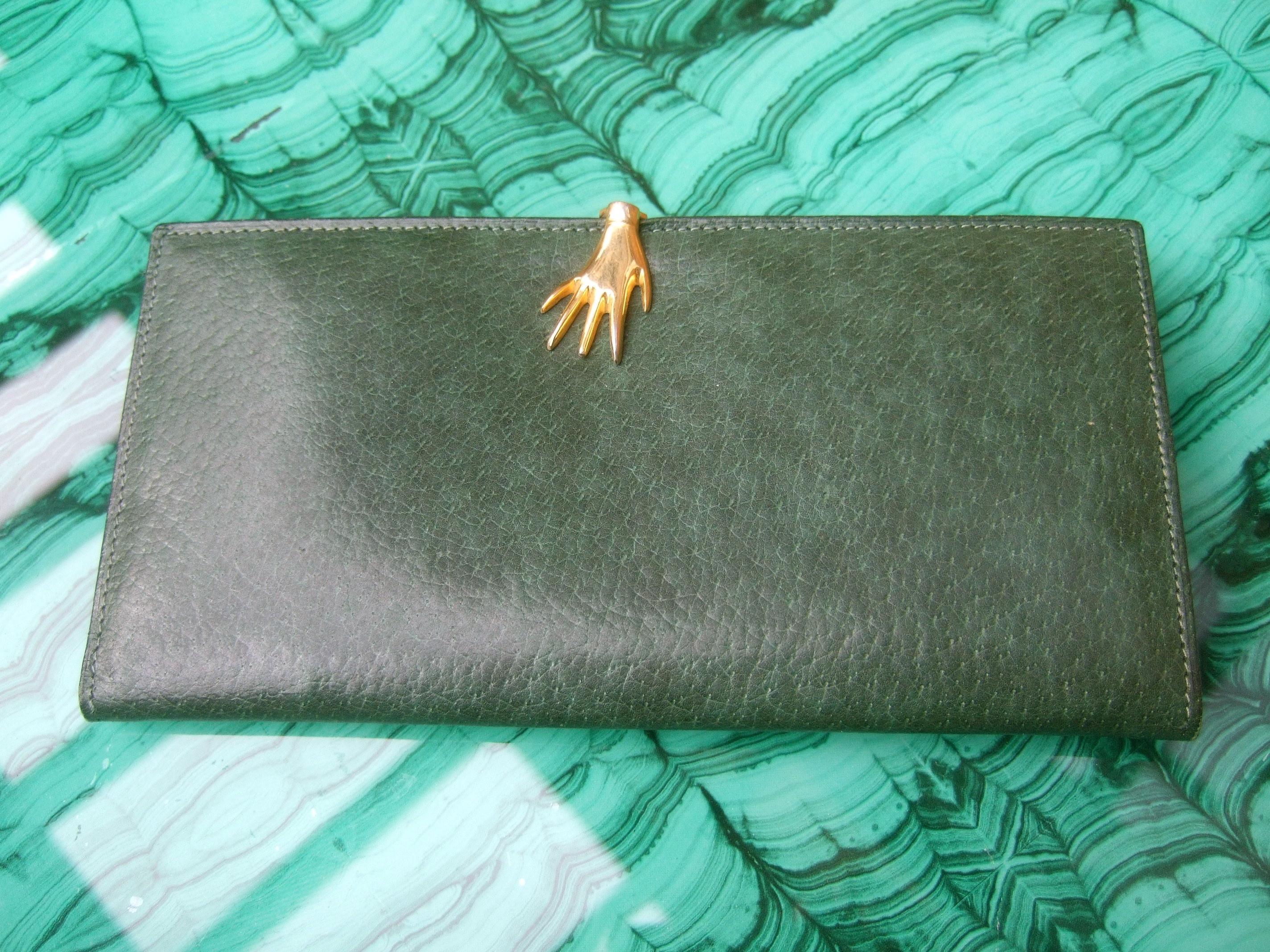 Gucci Italy Rare green pigskin leather hand clasp wallet in Gucci presentation box c 1970s
The stylish muted green leather wallet is adorned with a small gilt metal hand clasp closure
The interior is designed with twin slip pocket compartments 

The