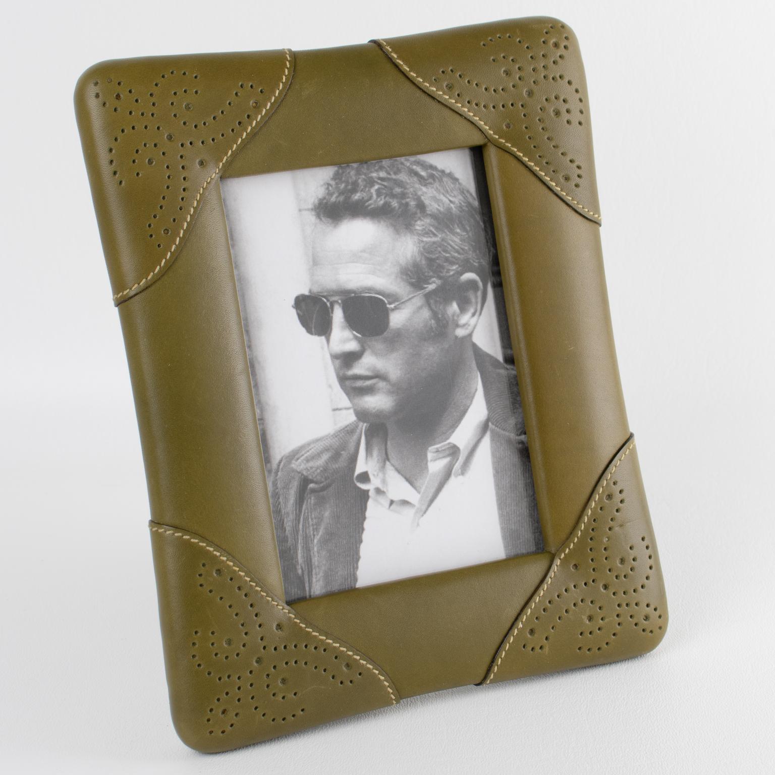 Add luxury to your interior with this picture frame created by Italian designer Gucci circa 1970. The timeless and elegant sage green calfskin leather has a textured pattern with ornate hand-stitched and pierced decor. The back and easel are the