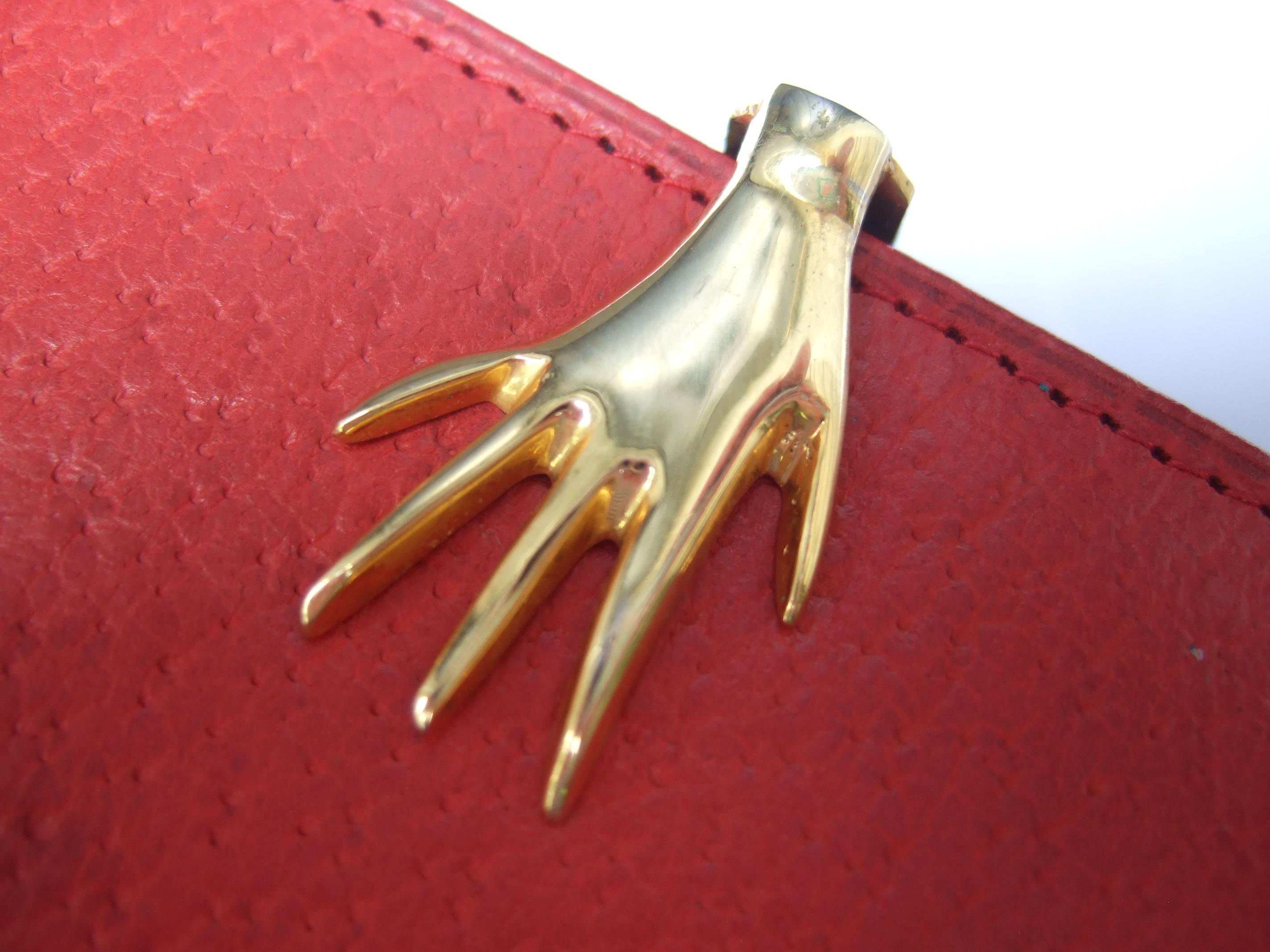 GUCCI Italy Rare red & black leather wallet in original Gucci cardboard presentation box c 1970s 
The stylish Italian wallet is adorned with a gilt metal hand clasp mechanism 
The interior in contrast is lined in black leather designed with two slip