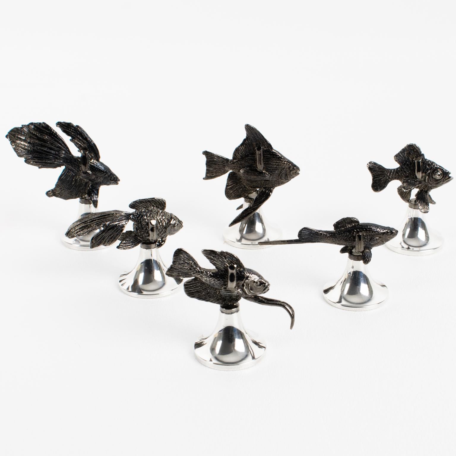 Dine in style with these whimsical silver plate luxury place card holders designed by Gucci, Italy. The set of six pieces features a silver plate rounded pedestal base with silver plate metal carved exotic fishes with a black finish patina, all