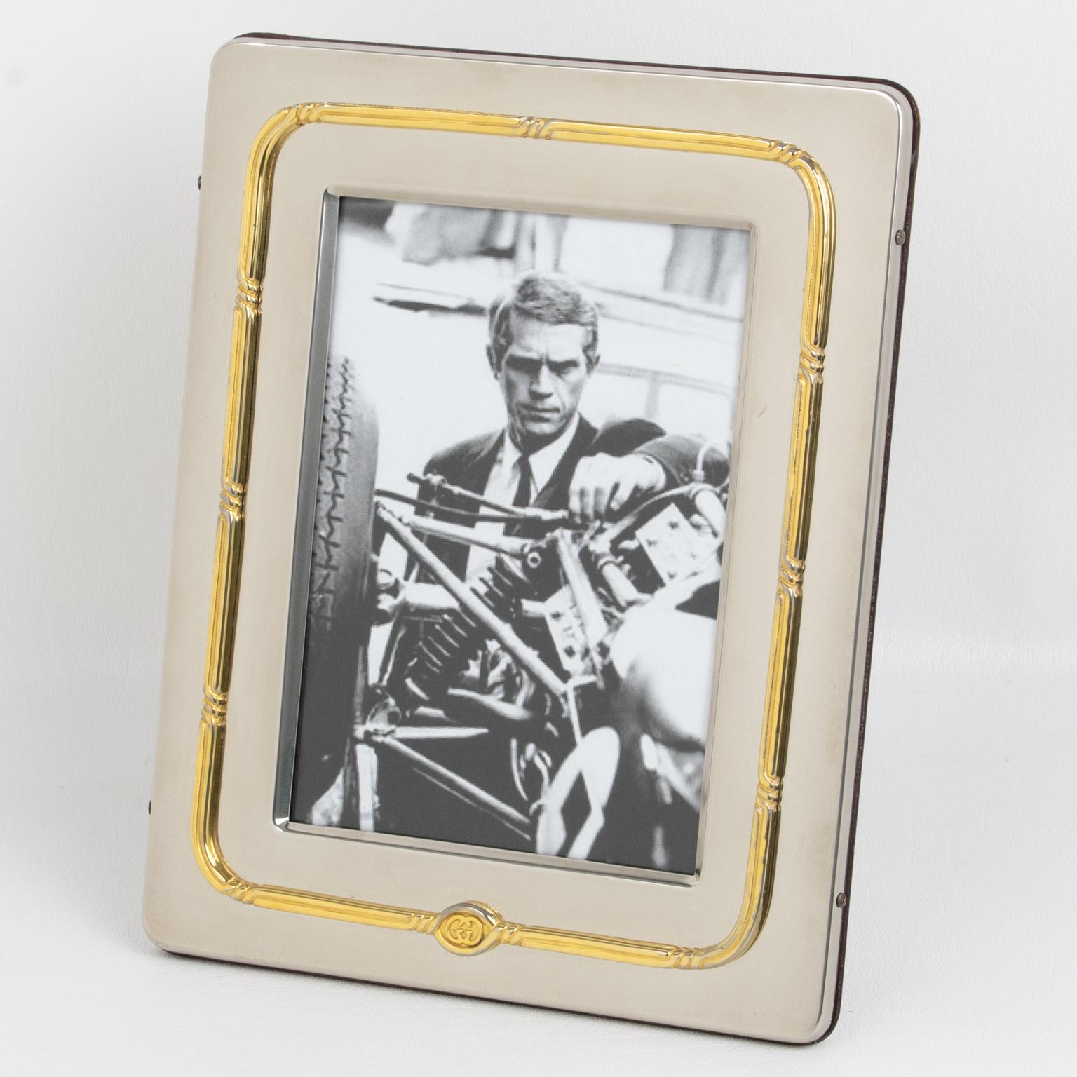 Italian designer Gucci crafted this ultra-chic picture photo frame in the 1980s. The rectangular shape boasts rounded corners in silver plate metal with gold plate accents in the carved design around it. The GG brand logo is visible on the front and