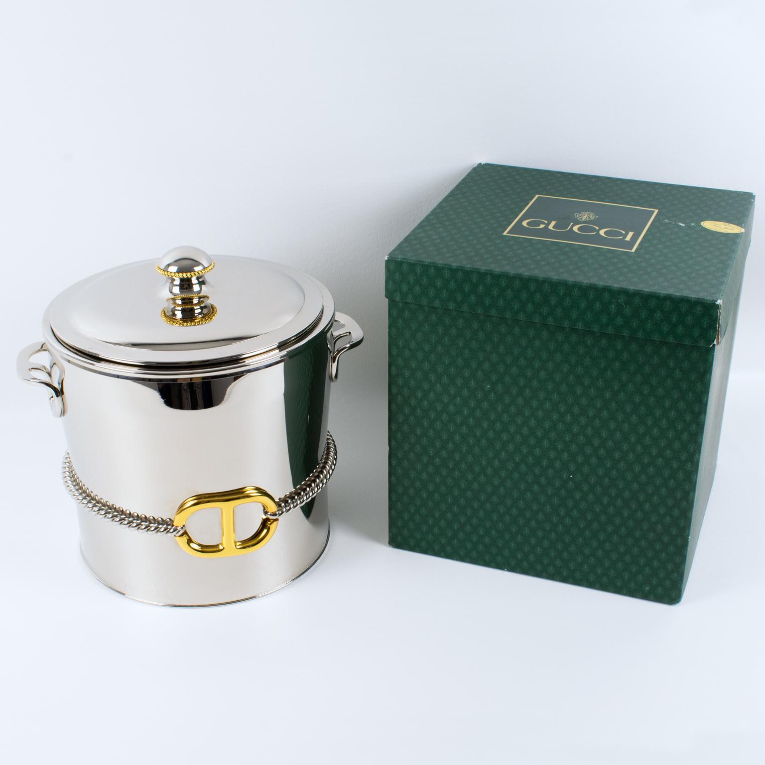 Gucci, Italy, crafted this luxury gold-plated and silvered metal barware ice bucket in the 1980s. This bar accessory has a sleek and modernist design. It is made from silvered metal with stylized GG handles and 24K gold plated Gucci GG logo decor