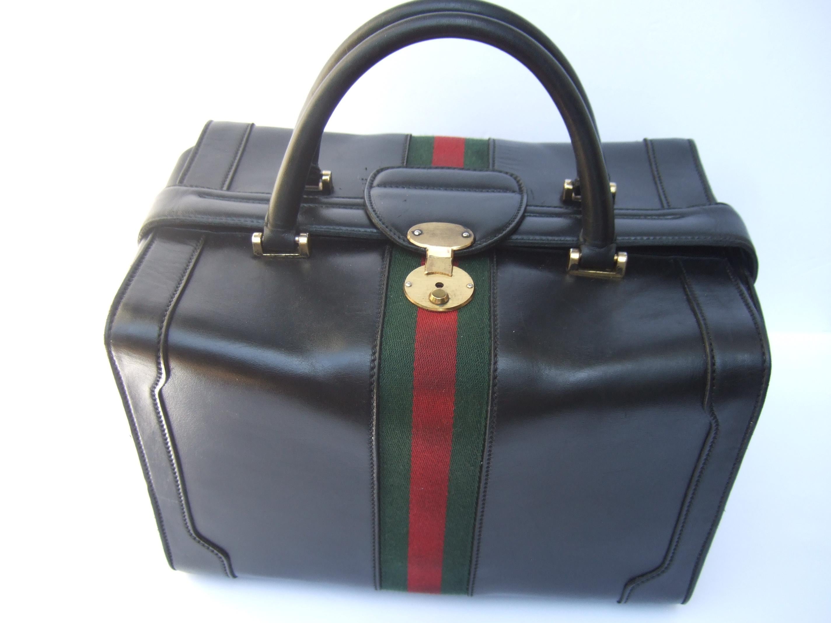 GUCCI Italy stylish rare structured black leather unisex train case c 1970s
The sturdy smooth black leather Italian travel case is adorned with Gucci's signature 
red & green canvas wool stripe

Carried with matching black leather swivel handles.