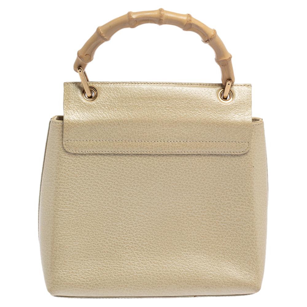 Crafted from ivory leather, Gucci's bag is classy and exudes elegance. It comes in a structured silhouette and a small flap that opens to a well-sized interior. The bag is held by a bamboo top handle so you can parade it in style.

