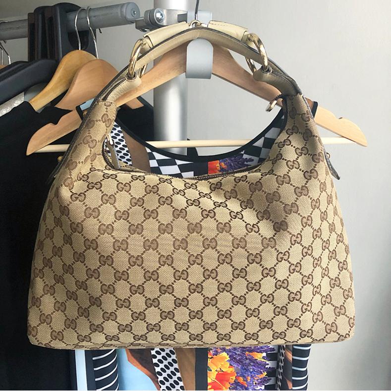 Gucci Ivory Monogram Canvas Horsebit Hobo Bag.  Zippered top, roomy interior, goldtone metal hardware.  Excellent pre-owned condition with some light wear to bottom corners as pictured.  Measures about 15.5 x 9 x 4.5” with a 6” strap drop.