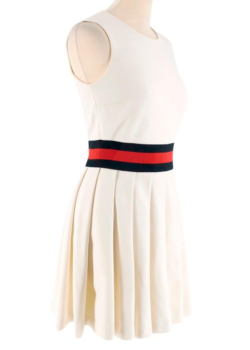 Gucci Ivory Pleated Gabardine Mini Dress

- Mid/heavyweight
- Red and navy jersey waistband referencing the label's signature 'web' stripe
- Round neck
- Hidden side zip and hook closure
- Pleated flared skirt
- Fitted bodice
-