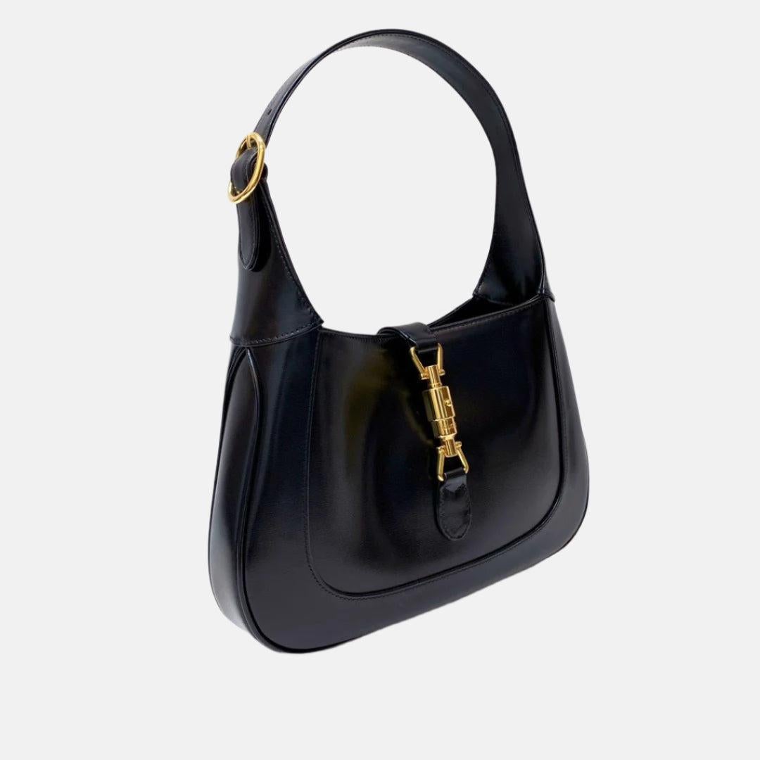 Gucci Jackie 1961 Black Leather Bag Small Piston Lock With Strap
 These are professional photos of the actual bag.
 The Gucci Jackie 1961 Handbag is a modern take on an iconic design. Crafted in leather with a structured silhouette, it features a