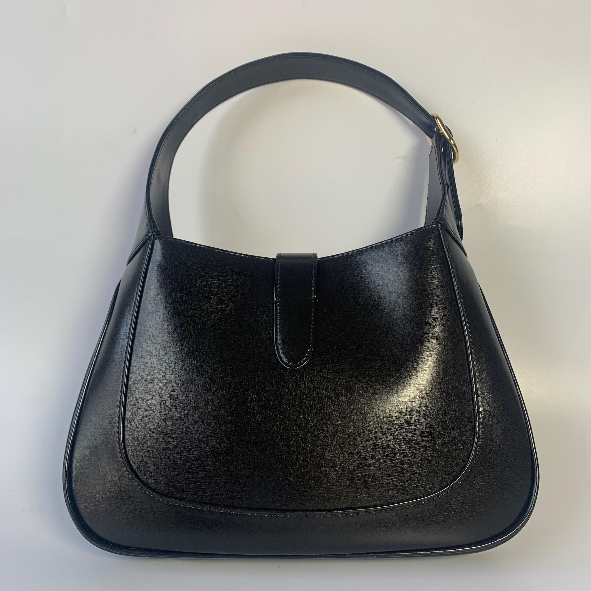 The Gucci Jackie 1961 Black Small bag is a modern take on an iconic design. Crafted in leather with a structured silhouette, it features a crossbody strap so you can bring your essentials wherever life takes you. 

Size small. The middle of all