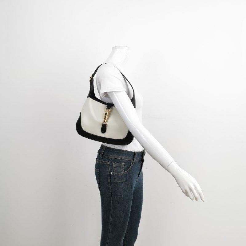 Gucci Jackie 1961 Black & White Leather Bag Small

  The Gucci Jackie 1961 Handbag is a modern take on an iconic design. Crafted in black and white leather with a structured silhouette, it features a crossbody strap so you can bring your essentials