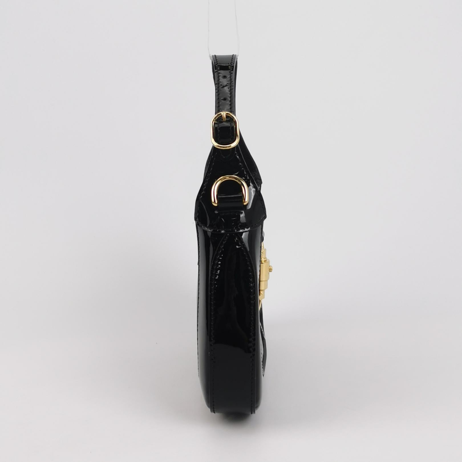 Gucci Jackie 1961 Mini Black Patent Leather Bag with Crystal Chain Strap
These are professional photos of the actual bag offered by Luxbags.
Gucci Jackie 1961 Mini size in black Leather Bag with adjustable Strap. This mini bag is perfectly petite,