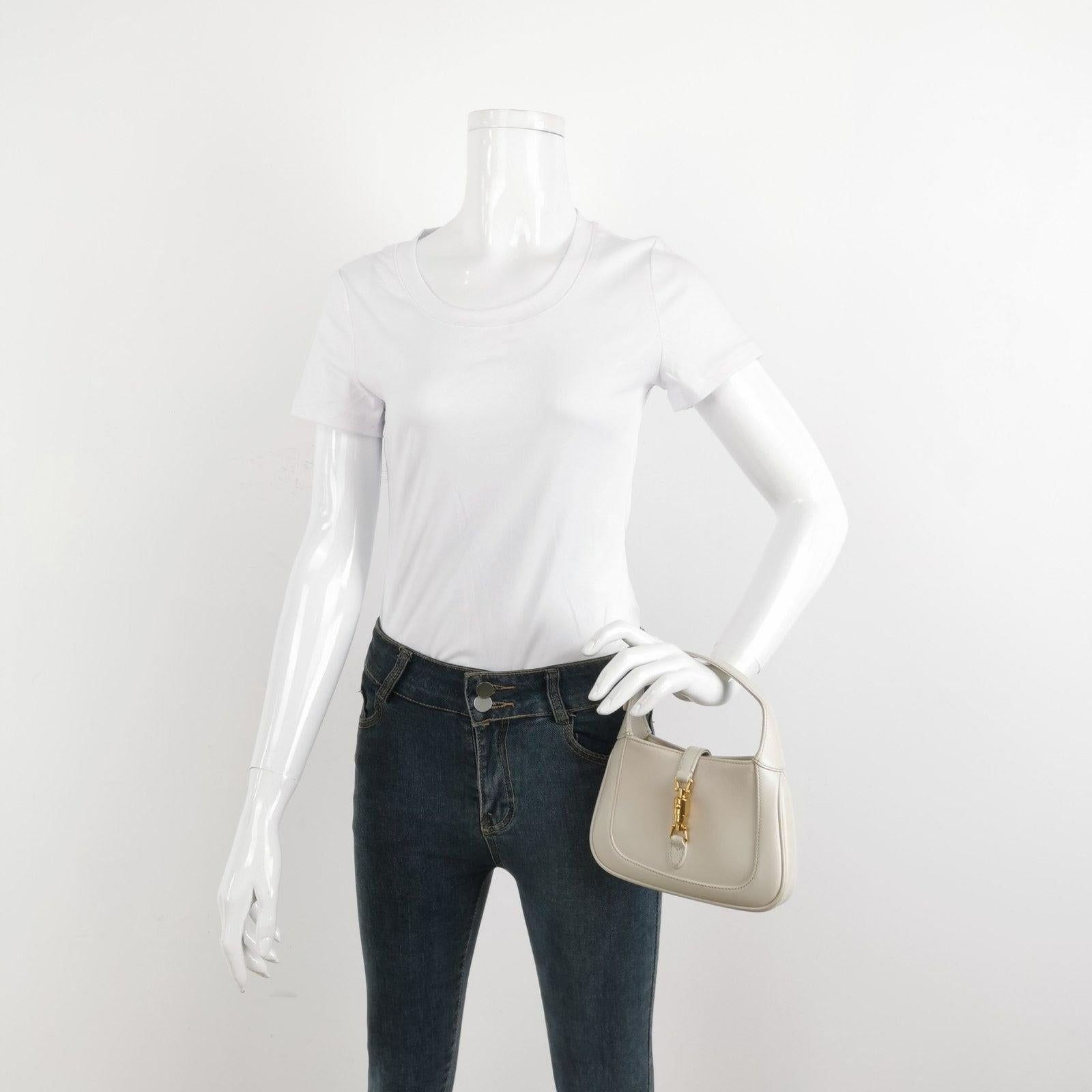 Gucci Jackie 1961 Mini Leather Bag with Adjustable Strap Size White These are professional photos of the actual bag offered by Luxbags. The Gucci Jackie 1961 White Small bag is a modern take on an iconic design. Crafted in leather with a structured