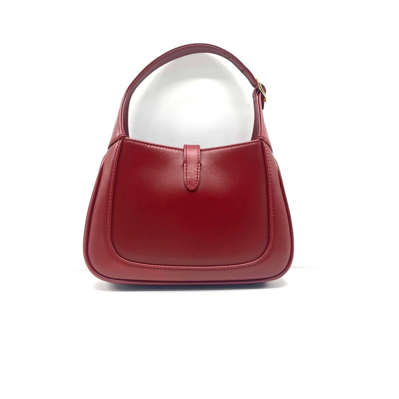 Gucci Jackie 1961 Mini Red Burgundy Leather Bag
 These are professional photos of the actual bag offered by Luxbags.
 The Gucci Jackie 1961 Burgundy mini bag is a modern take on an iconic design. Crafted in leather with a structured silhouette, it