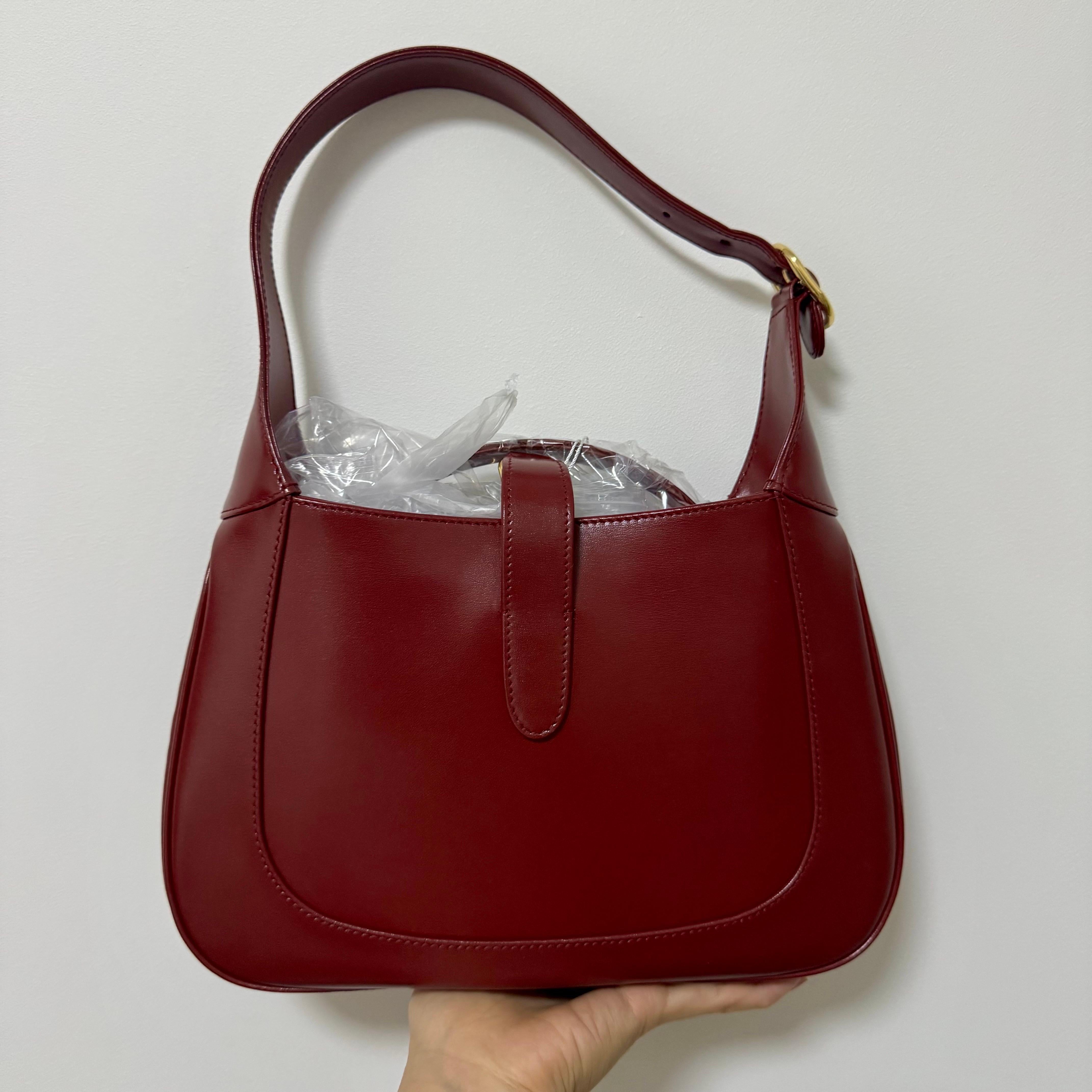 Gucci Jackie 1961 Red Leather Bag Small Shoulder Bag
These are professional photos of the actual bag offered by Luxbags.
The Gucci Jackie 1961 Red Handbag is a modern take on an iconic design. Crafted in leather with a structured silhouette, it