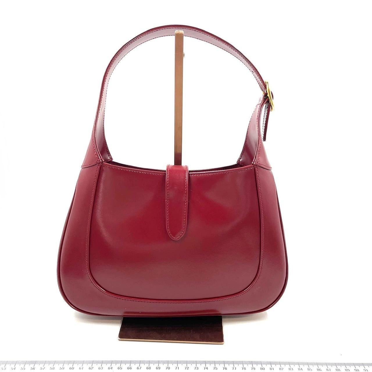 Gucci Jackie 1961 Red Leather Bag Small Shoulder Bag
 These are professional photos of the actual bag offered by Luxbags.
 The Gucci Jackie 1961 Red Handbag is a modern take on an iconic design. Crafted in leather with a structured silhouette, it