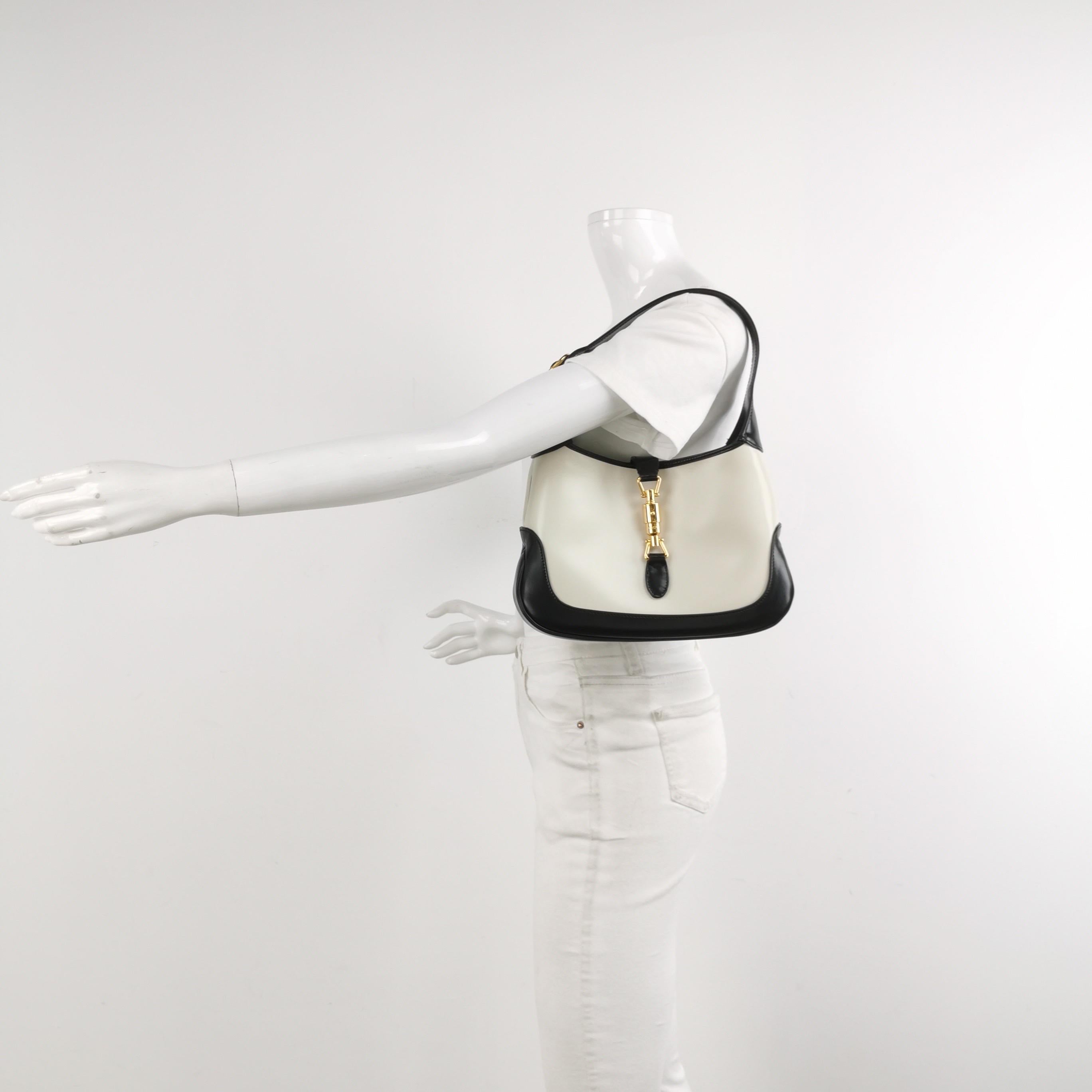 The Gucci Jackie 1961 Handbag is a modern take on an iconic design. Crafted in black and white leather with a structured silhouette, it features a crossbody strap so you can bring your essentials wherever life takes you. 

Condition: