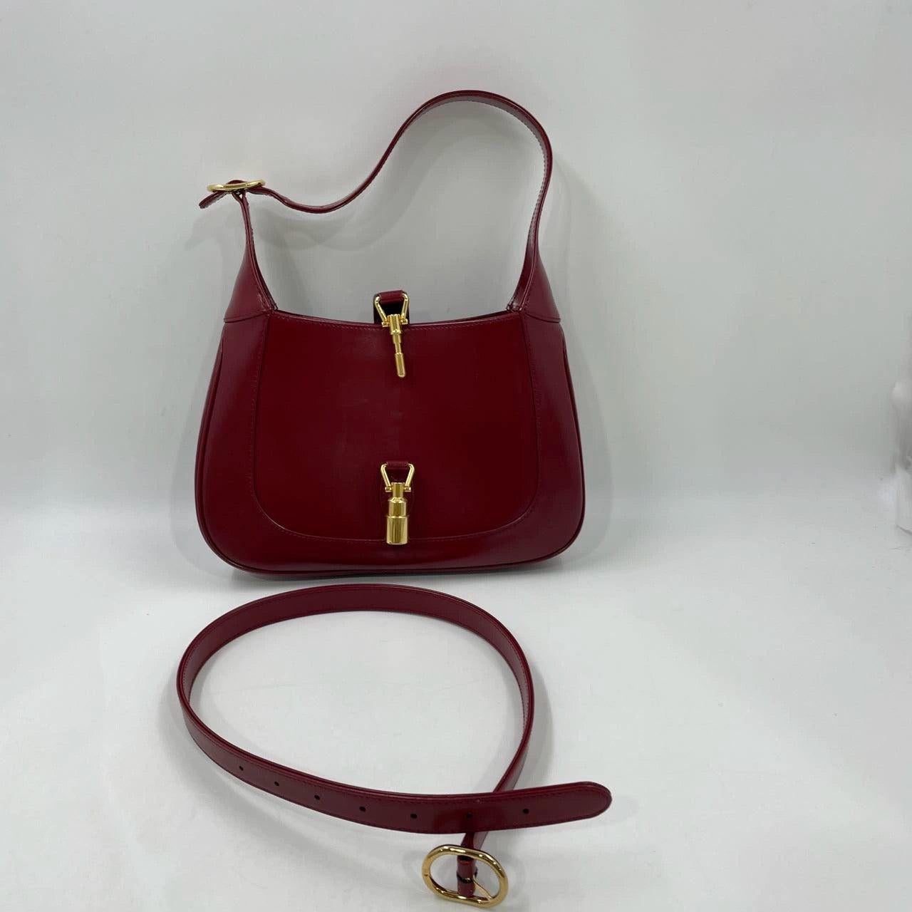 Gucci Jackie 1961 Small Burgundy Red Leather Bag with Adjustable Strap
 These are professional photos of the actual bag.
 The Gucci Jackie 1961 Red Handbag is a modern take on an iconic design. Crafted in leather with a structured silhouette, it