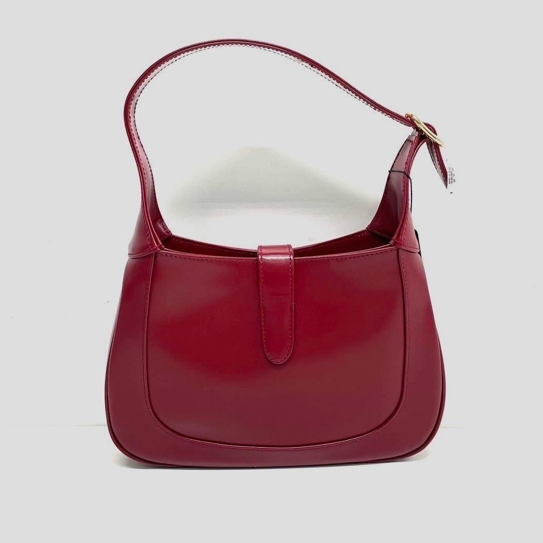 Gucci Jackie 1961 Small Burgundy Red Leather Bag with Adjustable Strap
 These are professional photos of the actual bag.
 The Gucci Jackie 1961 Red Handbag is a modern take on an iconic design. Crafted in leather with a structured silhouette, it