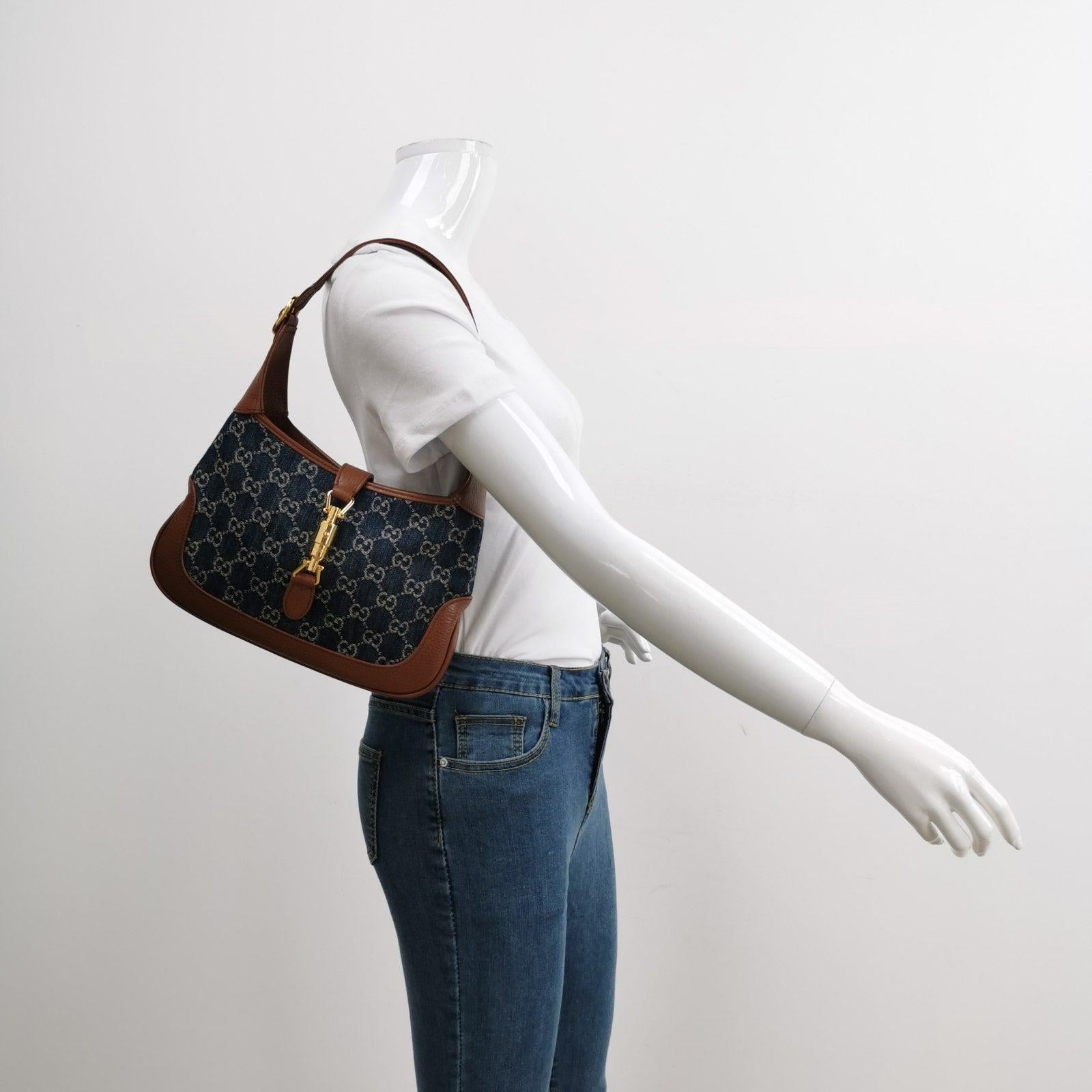 Gucci Jackie 1961 Small Handbag in Blue Monogram Denim and Brown Leather
  These are professional photos of the actual bag.
  The Gucci Jackie 1961 Handbag is a contemporary interpretation of a timeless style. Crafted with premium leather and