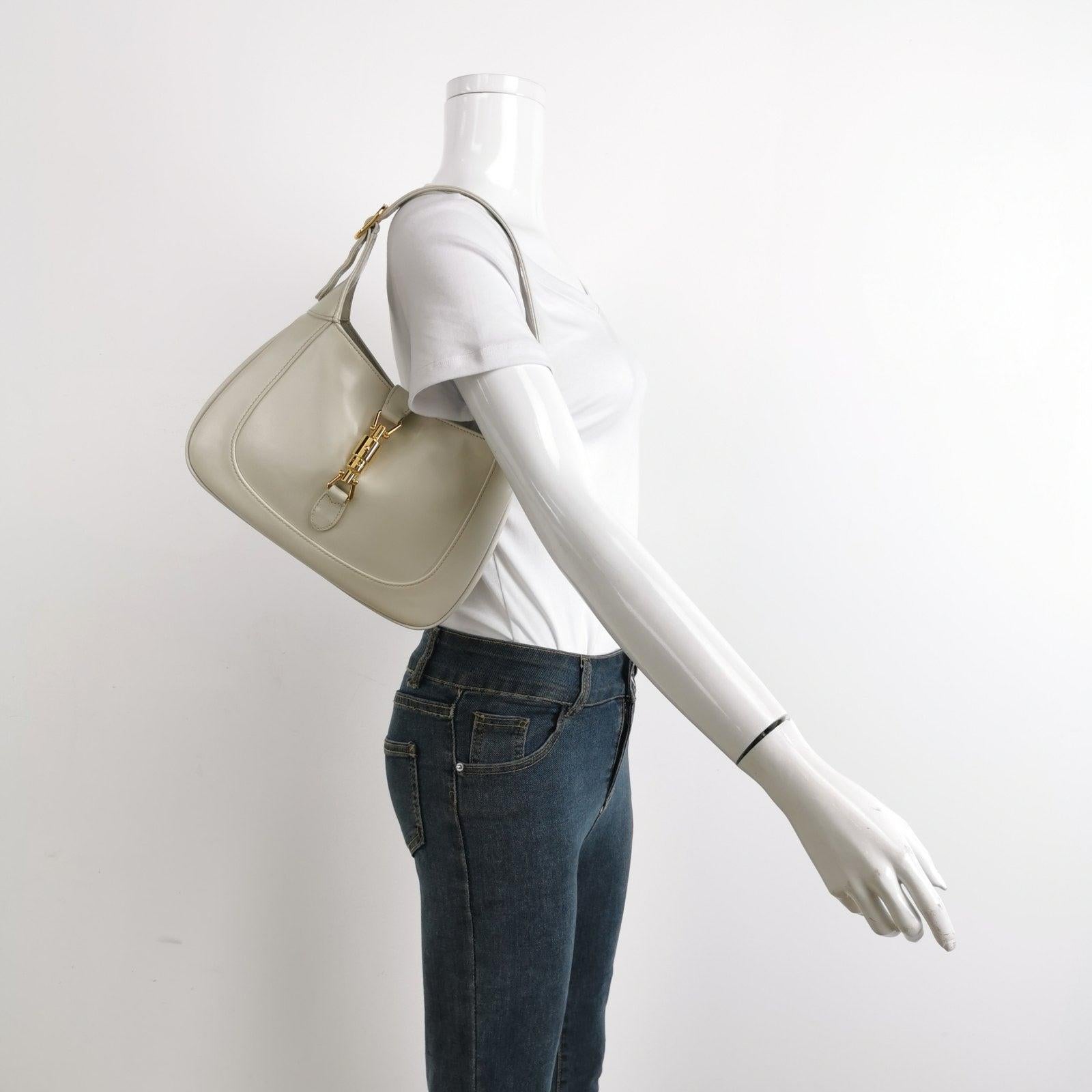 Gucci Jackie 1961 Small Leather Bag with Adjustable Strap Size White These are professional photos of the actual bag offered by Luxbags. The Gucci Jackie 1961 White Small bag is a modern take on an iconic design. Crafted in leather with a structured