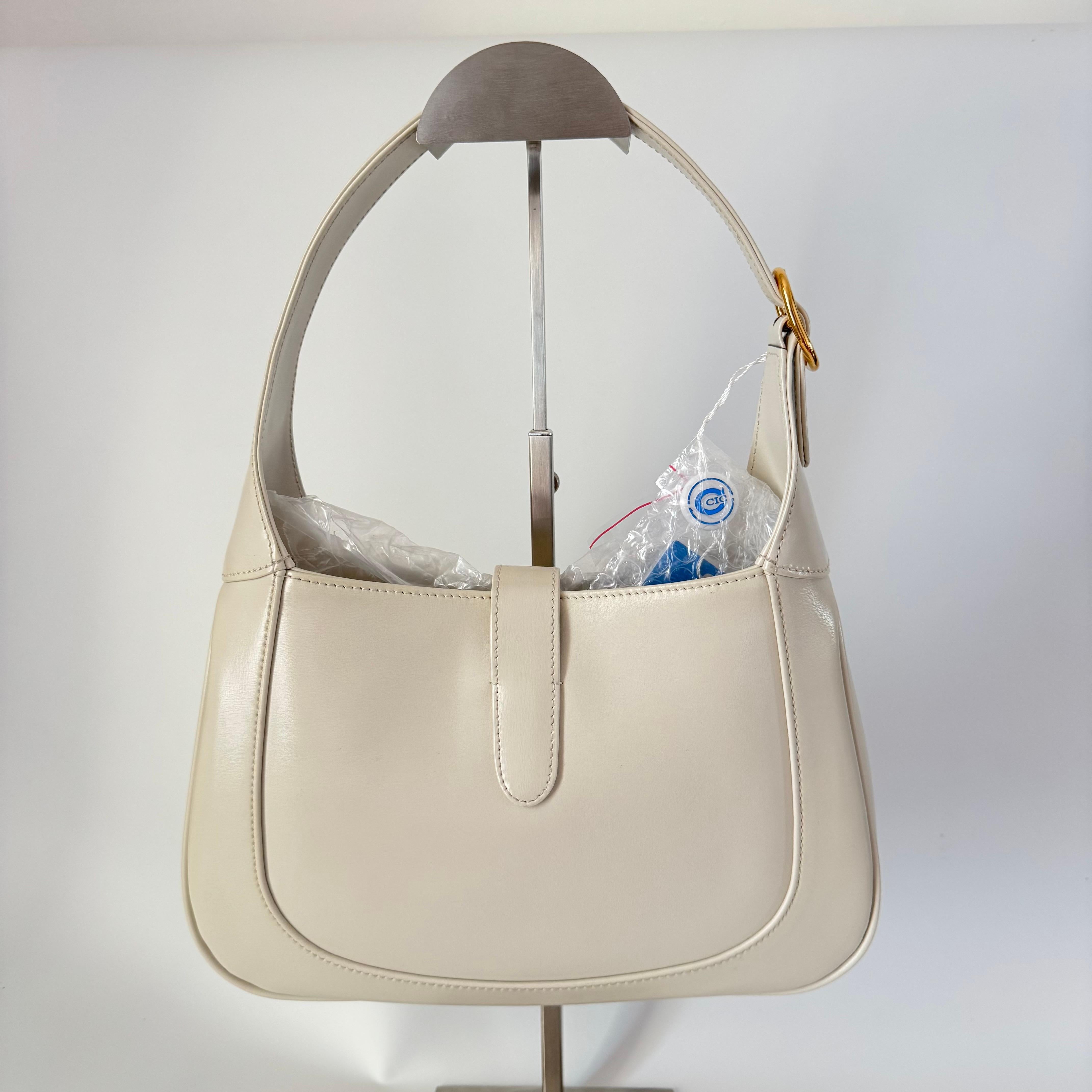 Gucci Jackie 1961 White Leather Bag with Adjustable Strap Size Small
  These are professional photos of the actual bag offered by Luxbags.
  The Gucci Jackie 1961 White Small bag is a modern take on an iconic design. Crafted in leather with a