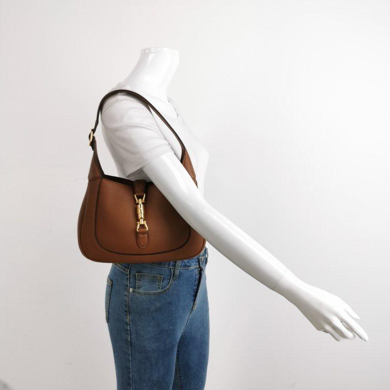Gucci Jackie 1961 Tan Brown Pebbled Leather Bag Small
 These are professional photos of the actual bag offered by Luxbags.
 
 The Gucci Jackie 1961 Black Small bag is a modern take on an iconic design. Crafted in soft pebbled leather with a