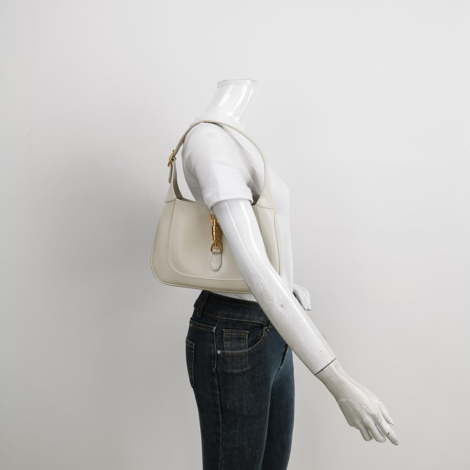 Gucci Jackie 1961 White Leather Bag with Adjustable Strap Size Small These are professional photos of the actual bag offered by Luxbags. The Gucci Jackie 1961 White Small bag is a modern take on an iconic design. Crafted in leather with a structured