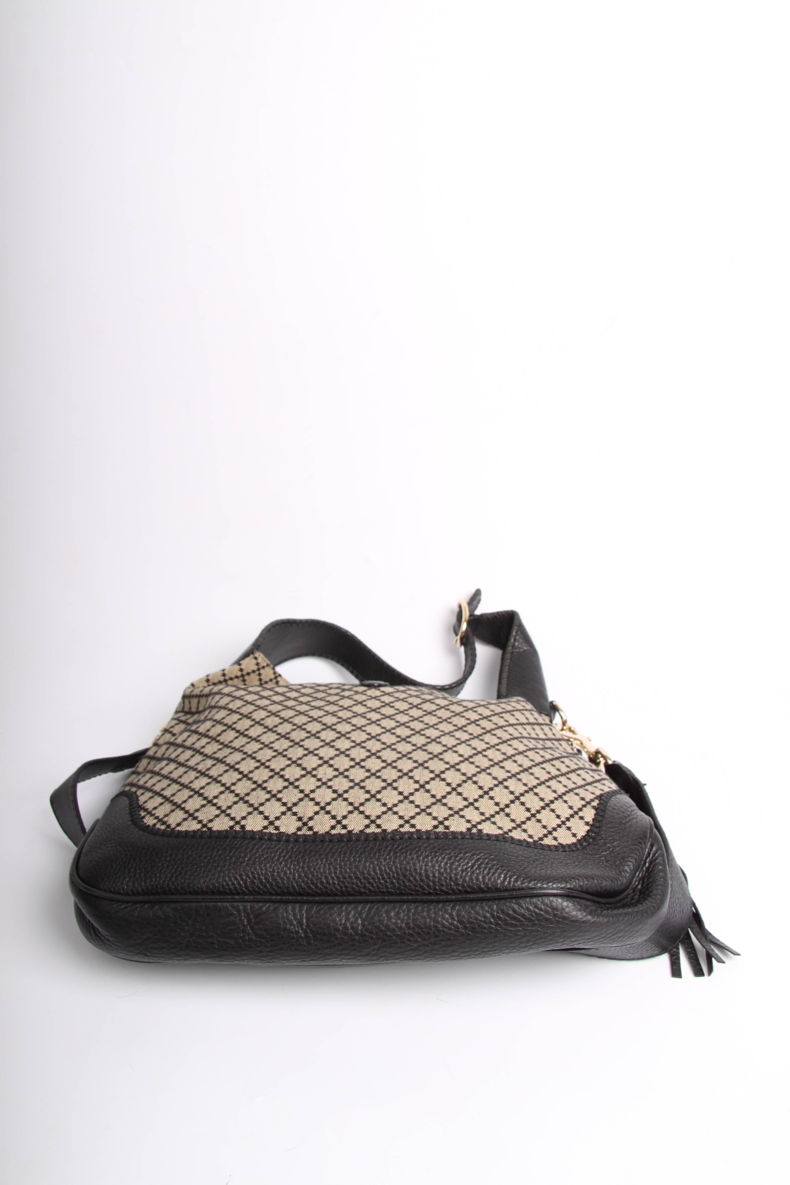 This is the Gucci Jackie Diamante Canvas Hobo Bag Medium crafted from black and grey canvas with black leather detailing.

Very suitable for daily use, the long shoulderstrap is detachable and the bag is very light weight. Silver-tone closure at the