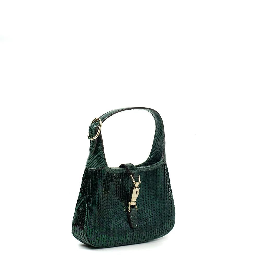 - Designer: GUCCI
- Model: Jackie
- Condition: Very good condition. Scratches on hardware
- Accessories: Dustbag
- Measurements: Width: 17cm, Height: 11cm, Depth: 3cm
- Exterior Material: Sequins
- Exterior Color: Green
- Interior Material: Cloth
-