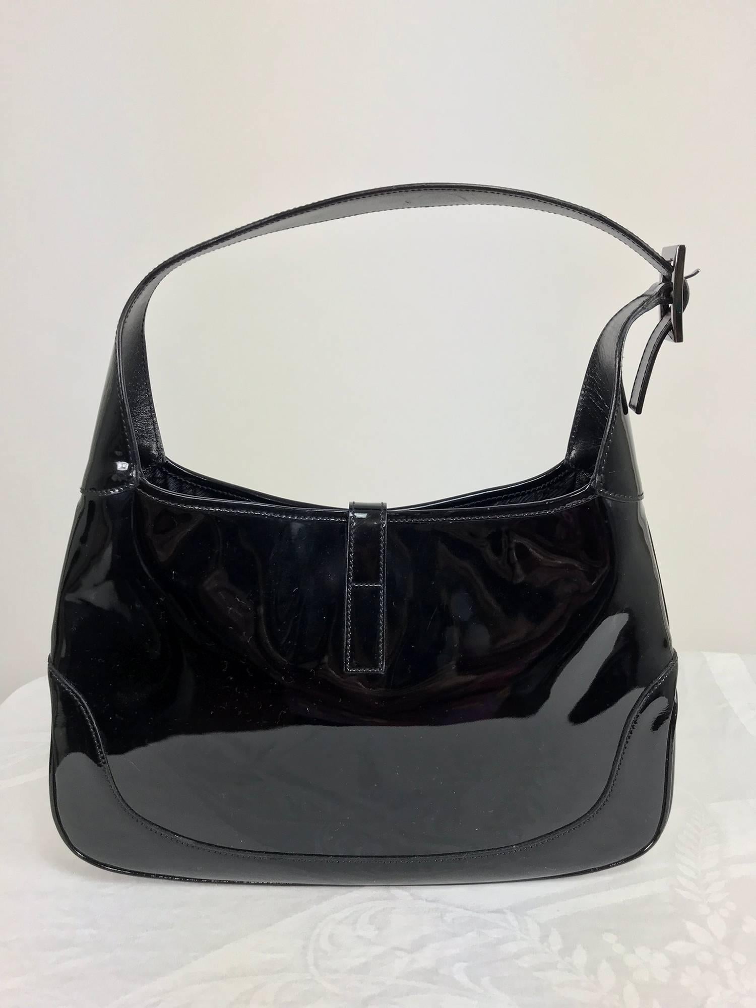 Gucci Jackie O black patent leather handbag...Always stylish this patent leather Gucci bag has silver hardware and is lined black Gucci logo fabric...Shoulder bag...In excellent condition with light wear...
Measurements are in inches:
13 wide at