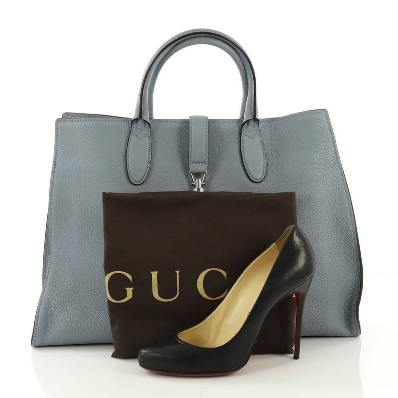 This Gucci Jackie Soft Tote Leather Large, crafted from blue leather, features a soft-structured silhouette, dual rolled handles, and silver-tone hardware. Its piston-lock closure opens to a blue suede interior with side zip pockets. **Note: Shoe