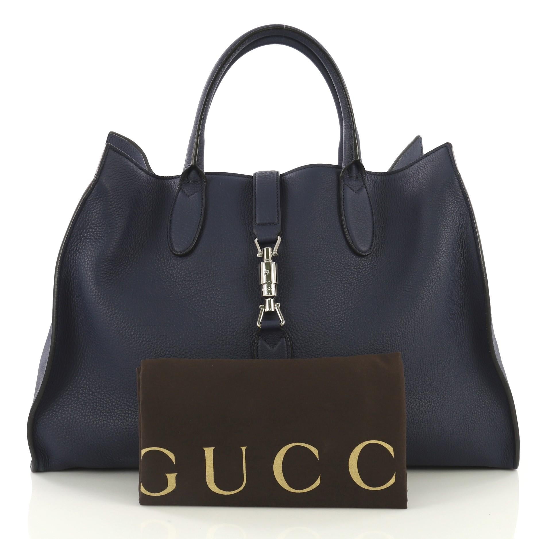 This Gucci Jackie Soft Tote Leather Large, crafted from blue leather, features dual rolled handles and silver-tone hardware. Its piston-lock closure opens to a blue suede interior with side zip pockets. 

Estimated Retail Price: $2,990
Condition: