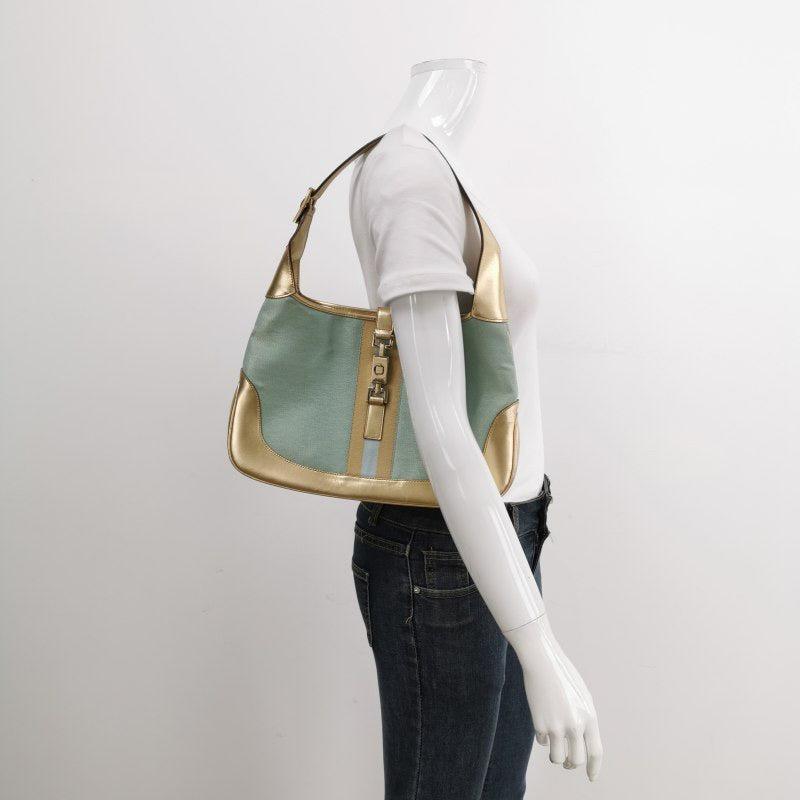 Gucci Jackie Vintage Mini Blue Nylon with Gold Leather Shoulder Bag Medium
These are professional photos of the actual bag.
  Brand: GucciModel: Jackie VintageExterior Material: Nylon and leatherExterior Color: Blue and goldInterior Material: Silk