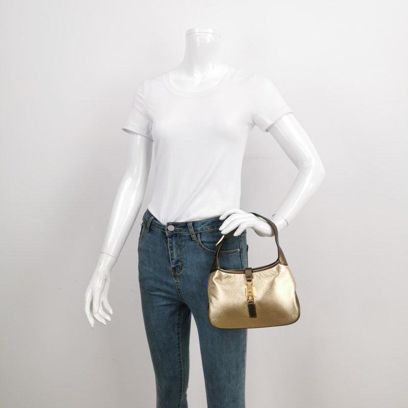 Gucci Jackie Vintage Mini Gold Lambskin Leather Brown Calfskin Leather
These are professional photos of the actual bag.
  This Gucci Jackie vintage comes in rare mini size crafted from shimmering gold lambskin leather, and metallic brown calfskin