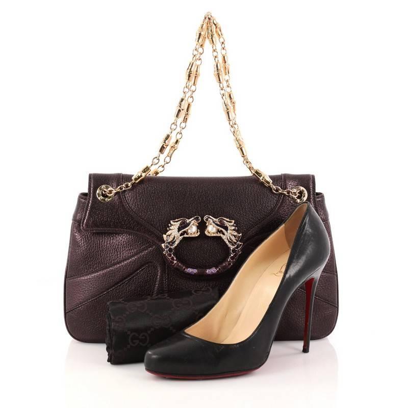 This authentic Gucci Jeweled Dragon Bag Leather created by Tom Ford for Gucci is a definite must-have for the ultra chic woman. Crafted from metallic purple leather, this stylish bag features an elegant, flat silhouette, gold chain strap,