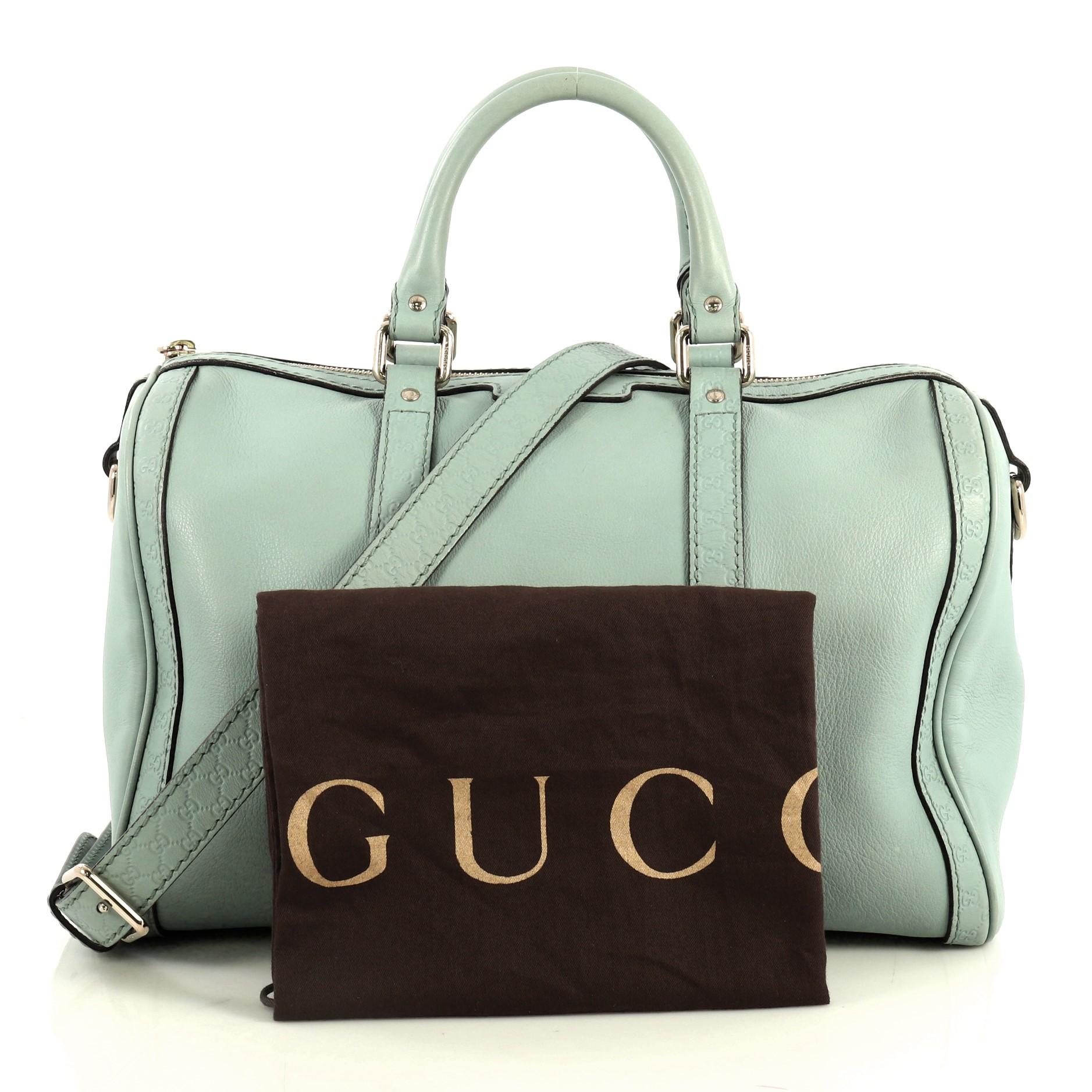 This Gucci Joy Boston Bag Leather with Microguccissima Medium, crafted from blue leather, features dual rolled handles, microguccissima leather trim and gold-tone hardware. Its zip closure opens to a neutral canvas interior with slip