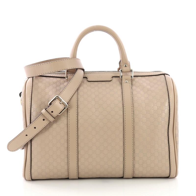 This Gucci Joy Boston Bag Microguccissima Leather Medium, crafted in Beige Microguccissima Leather, features dual rolled handles, leather trims, and gold-tone hardware. Its top zip closure opens to a beige canvas interior with zip and slip pockets.