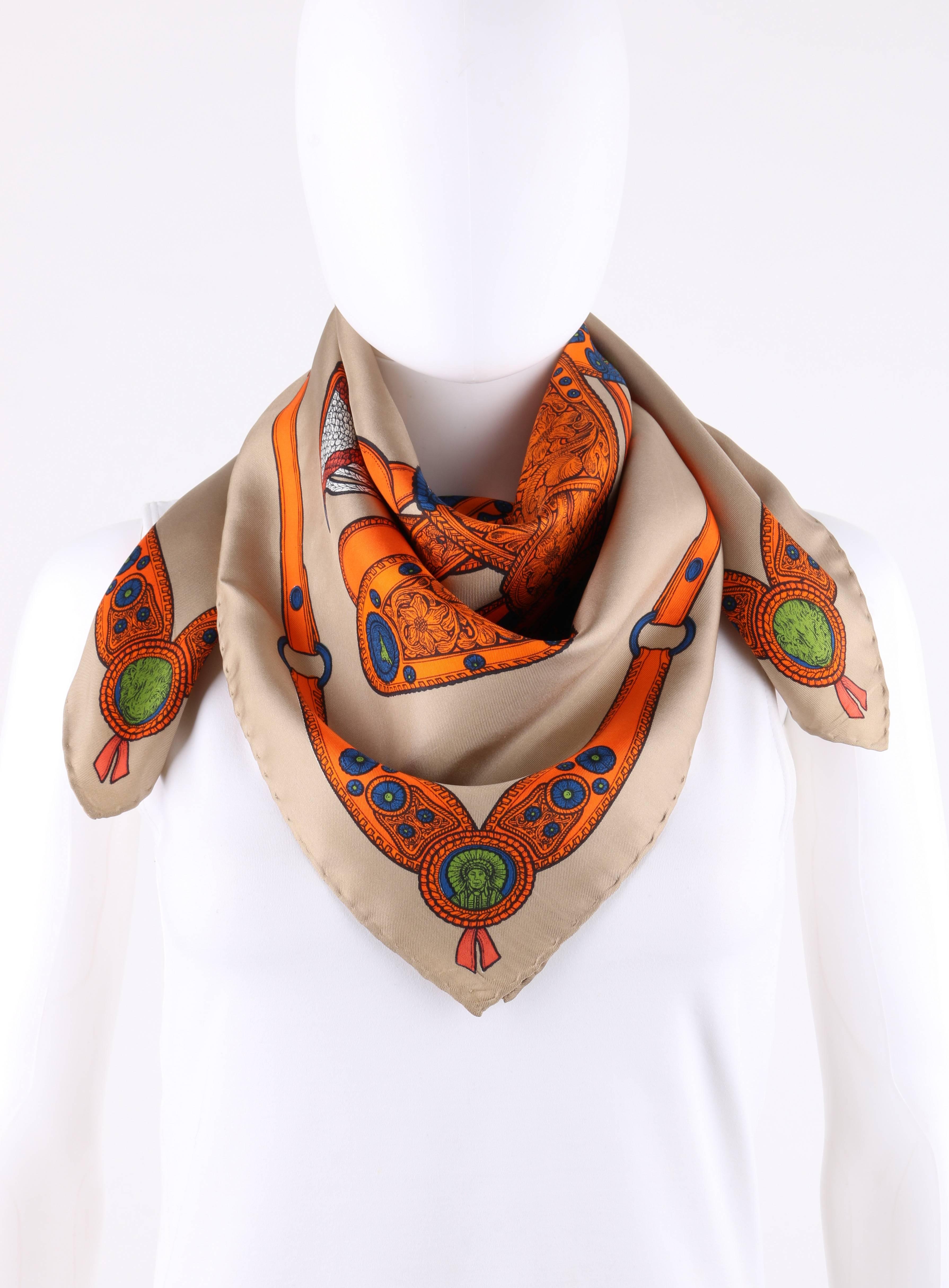 Gucci Khaki and orange southwestern saddle equestrian print silk scarf. Khaki background. Orange, royal blue, and green central saddle with ornate floral and southwestern detail throughout. Southwestern style belt boarder with buffalo and chief