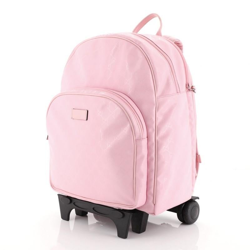 This Gucci Kid's Trolley Backpack GG Coated Canvas, crafted from pink GG coated canvas, features adjustable shoulder straps, retractable handle, exterior front zip pocket and silver-tone hardware. Its zip closure opens to a pink nylon interior.