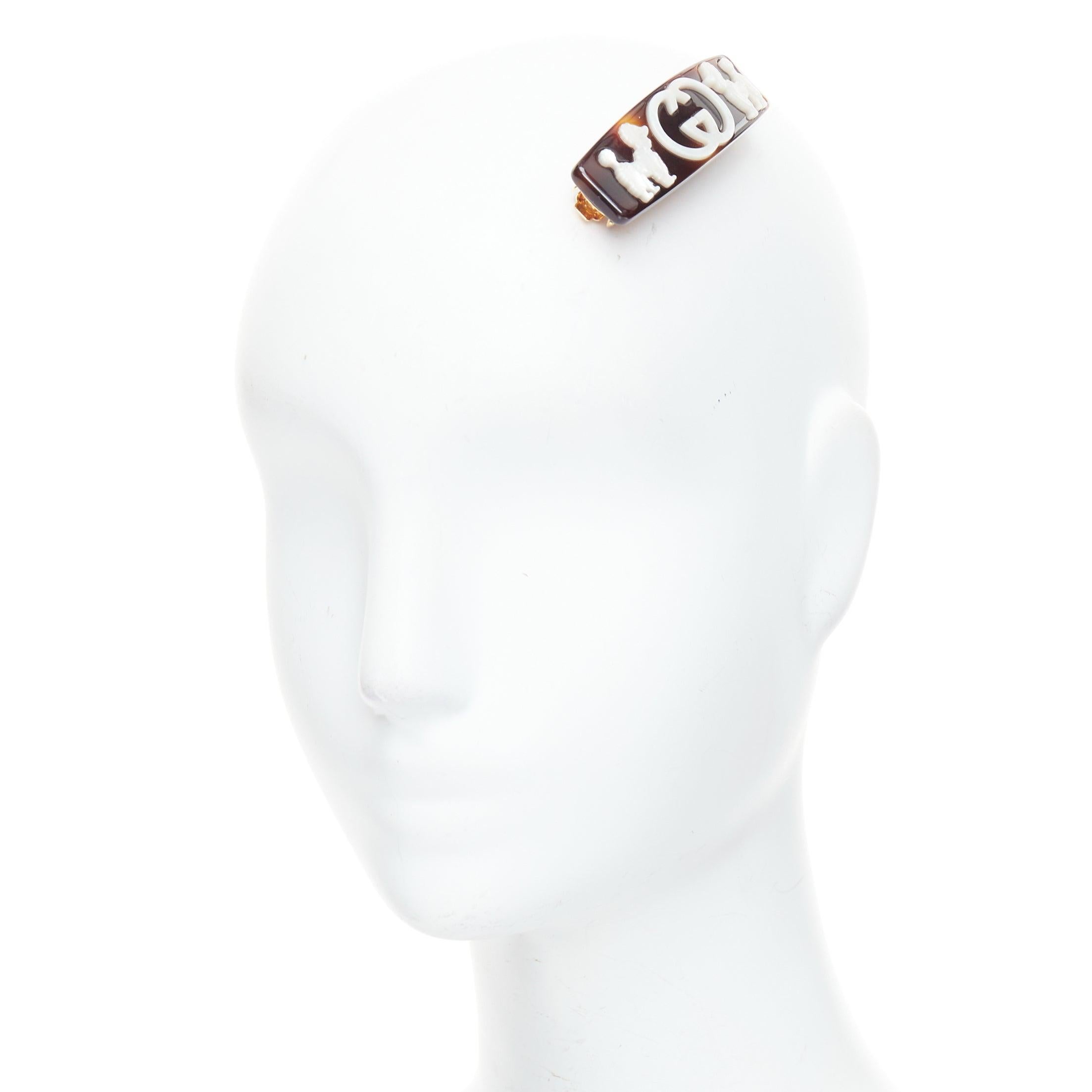 GUCCI Kids white tortoise mother of pearl poodle GG resin hair barette
Reference: KYCG/A00139
Brand: Gucci
Collection: Kids
Material: Resin, Metal
Color: Brown, White
Pattern: Logomania
Closure: Clip On
Extra Details: Havana brown tortoiseshell